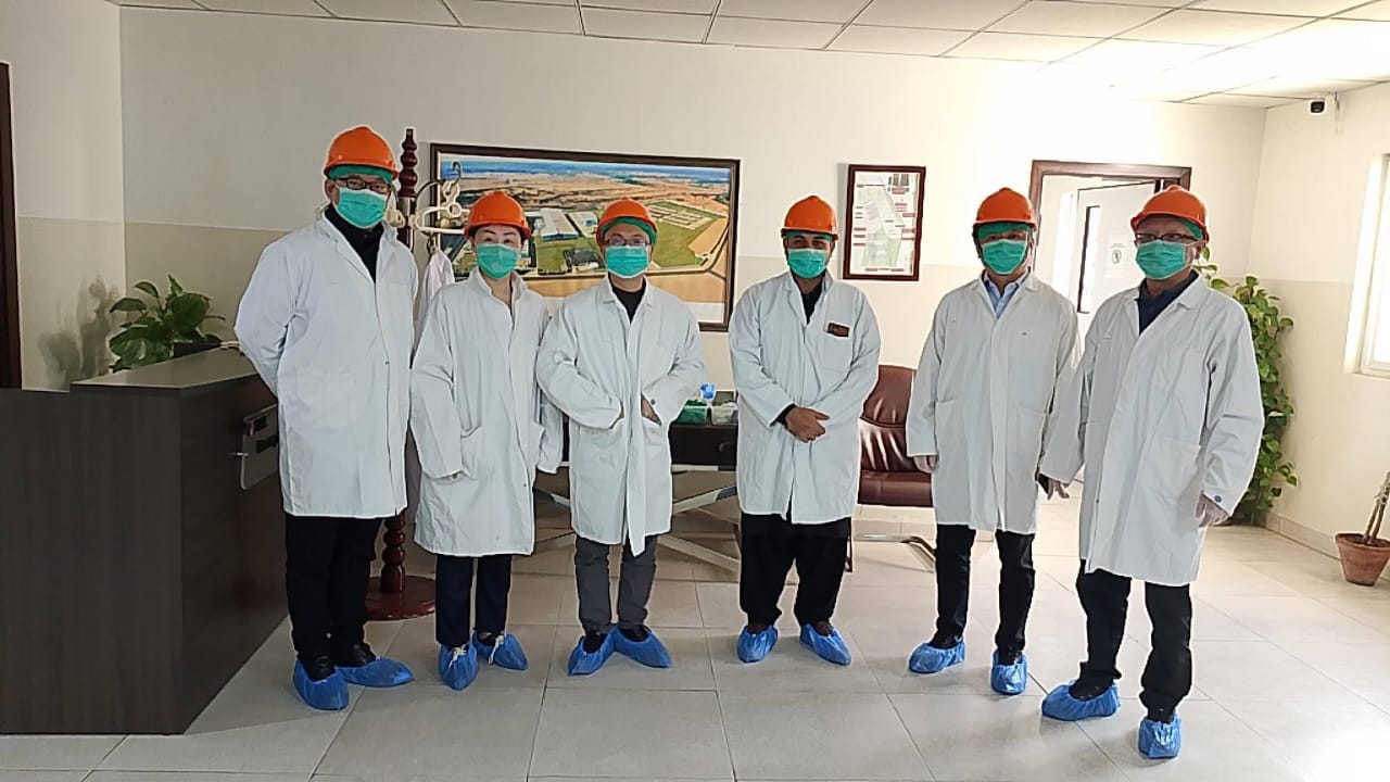 Technical site visit with safety gear and lab coats